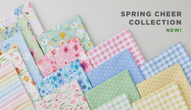 A selection of fat quarter fabrics of springtime prints in a pastel palette from the Spring Cheer Fabric collection by Clothworks.