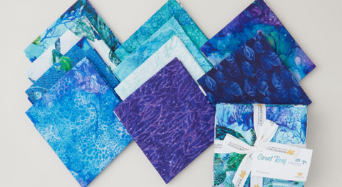 A fat quarter bundle of blue, purple, and green ocean-inspired prints from the Coral Reef fabric collection.