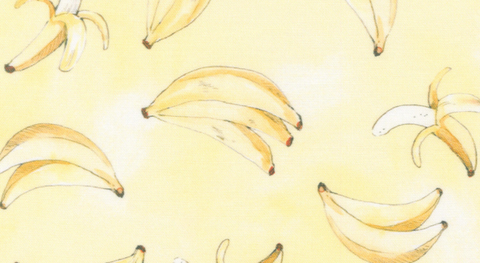 Bananas tossed on a yellow background. 