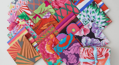 A selection of fat quarter prints from the warm collection of the Kaffe Fasset collective february 2026 fabric collection.