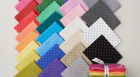 Fat quarter bundle of cotton quilting fabric with spots in assorted colors. 