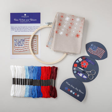 Red, White and Bloom embroidery kit contents: stitch guide, printed canvas, bamboo hoop, floss skeins, scissors and needles